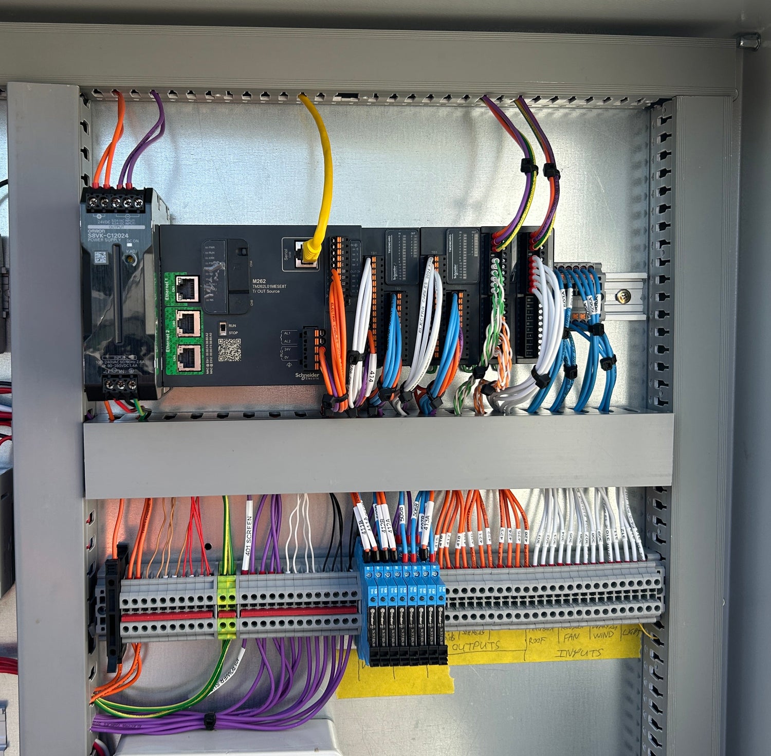 Electrical panel with various wires and components inside a cabinet From Robot Solutions QLD