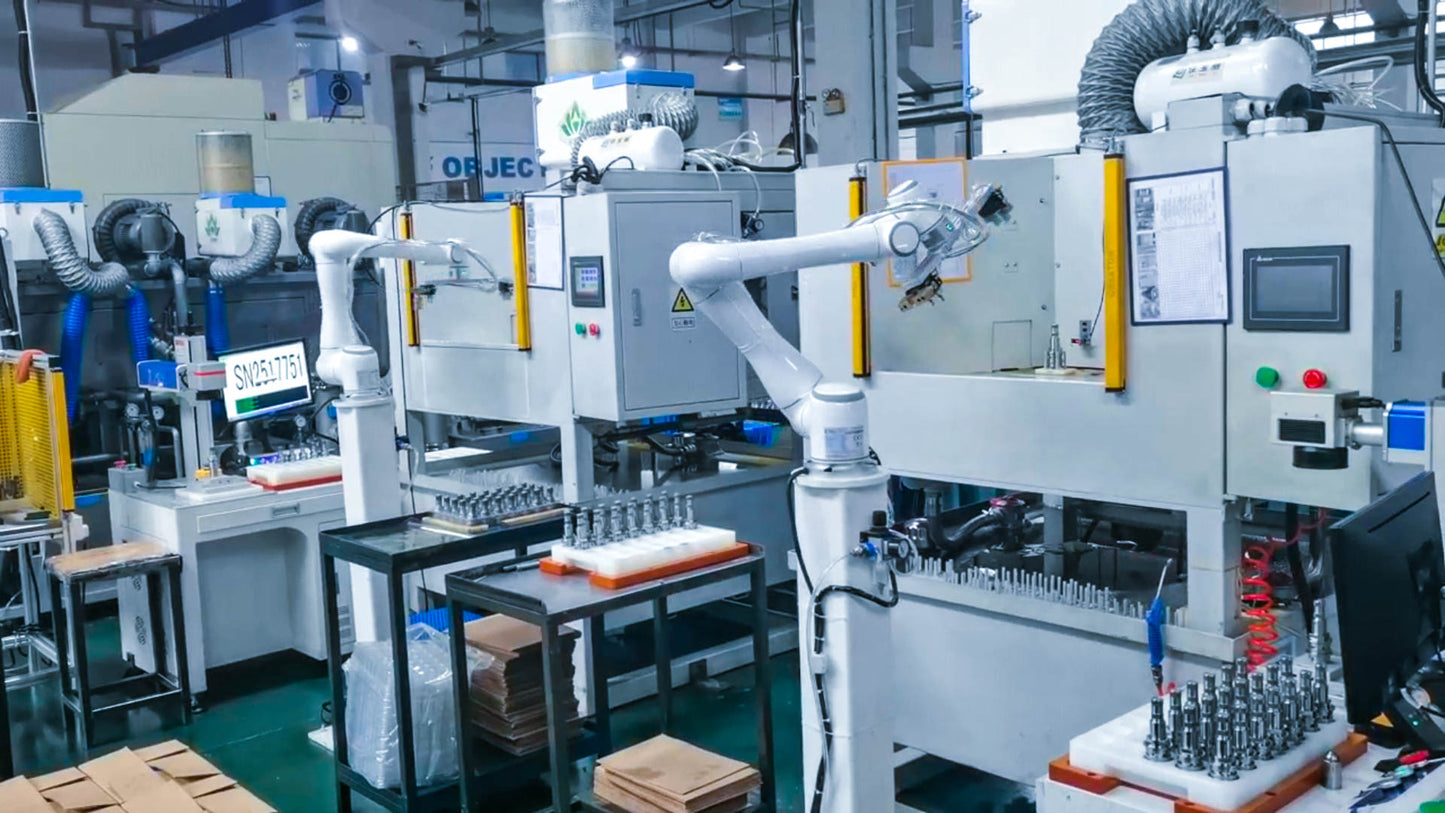 Automated manufacturing line with robotic arms and industrial equipment in a factory setting.