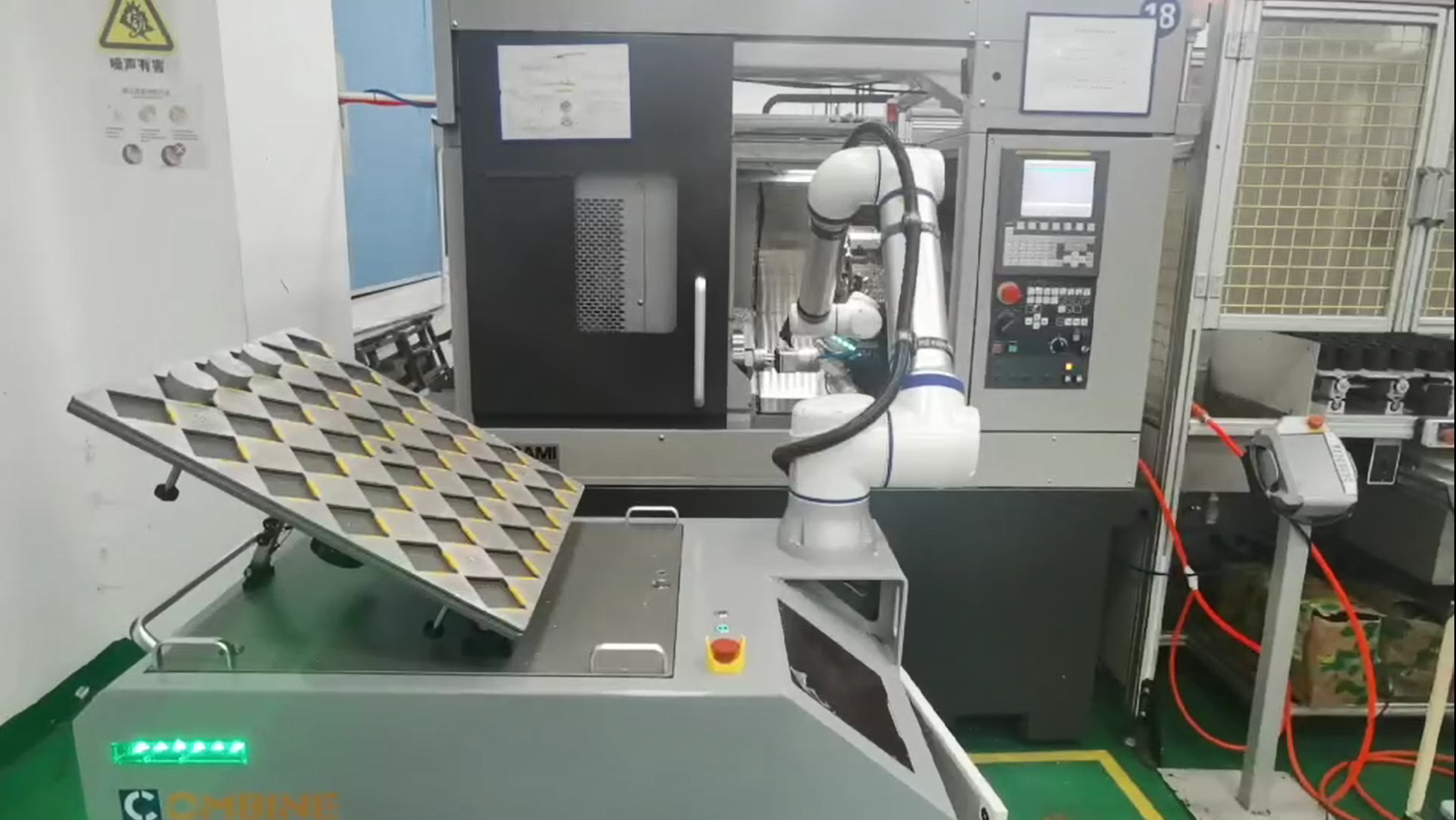 Elite Cobot Robotic arm in a manufacturing setting with industrial equipment and materials.