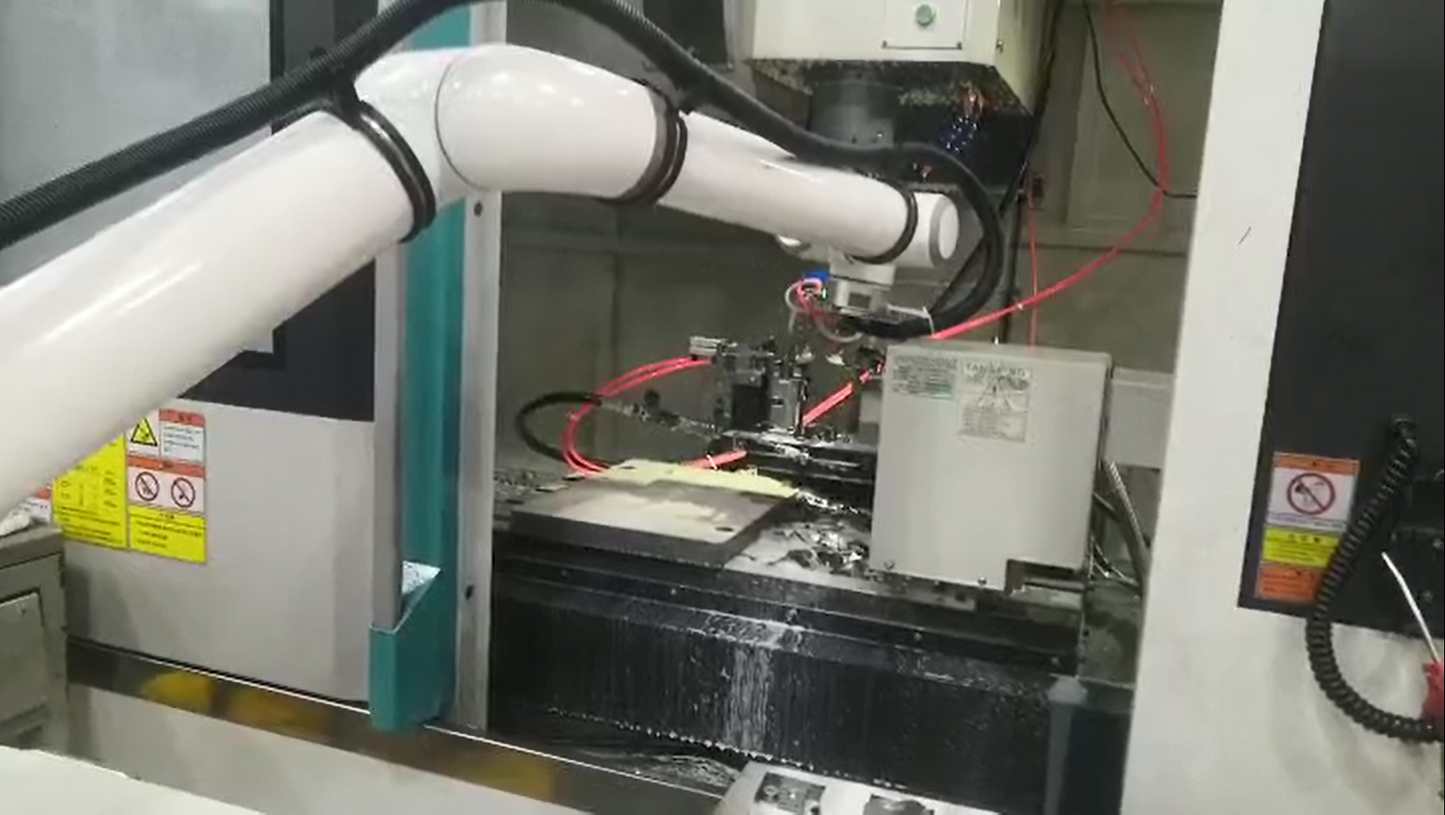 Elite Cobot from Robot Solutions QLD Robotic arm in a manufacturing setting with various components and wires.